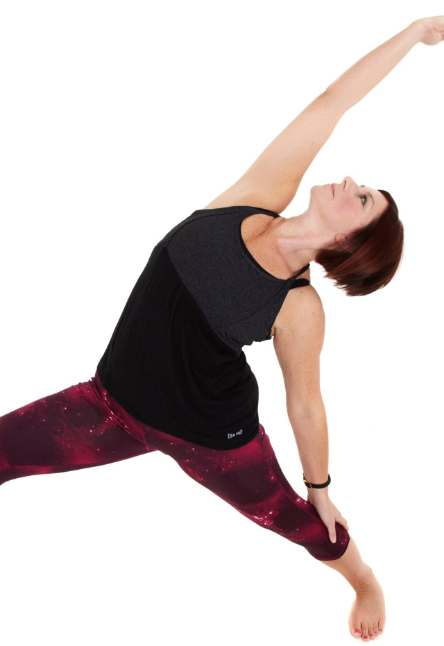 Rebecca performing a side plank yoga stretch pose